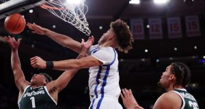 การที่รัฐมิชิแกนรื้อถอนรัฐเคนตักกี้เน้นย้ำถึงความแตกต่างทางปรัชญาในบาสเก็ตบอลระดับวิทยาลัย